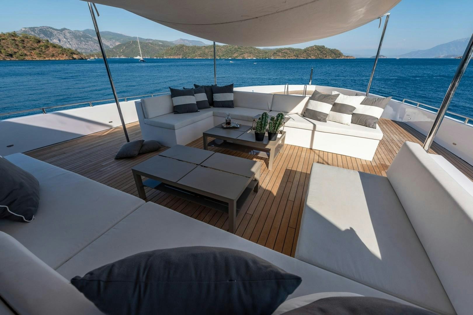 a room with a couch and a table on it aboard OCEAN BREEZE Yacht for Sale