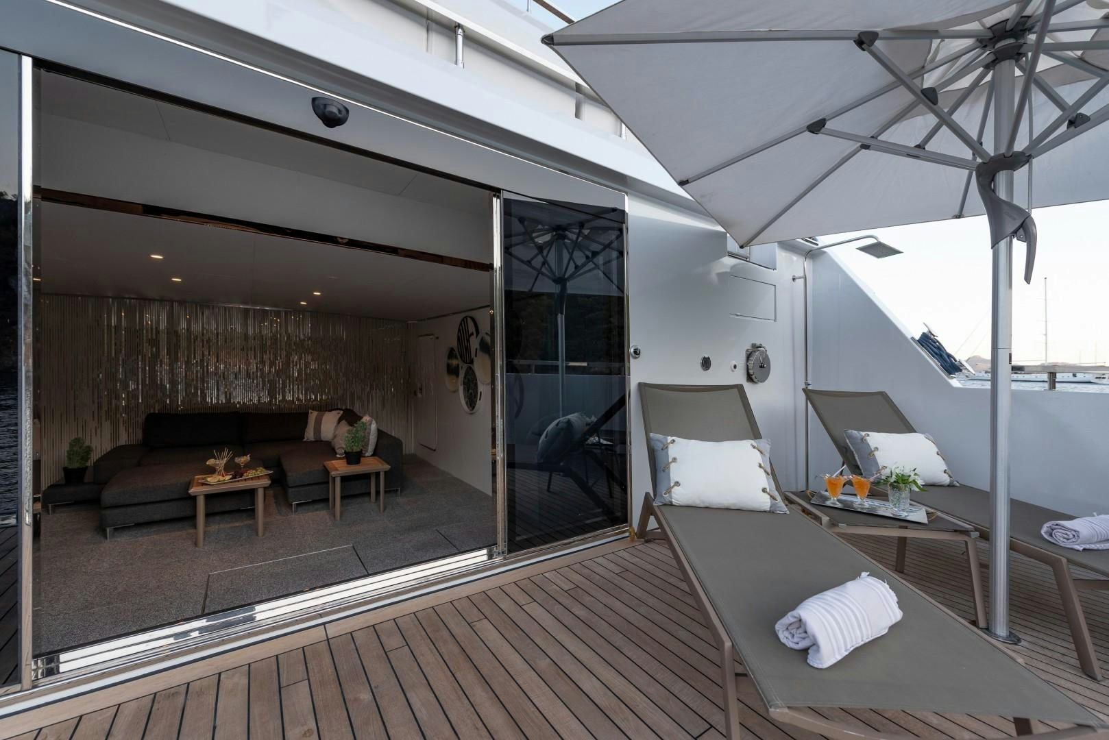 a large room with a wood floor aboard OCEAN BREEZE Yacht for Sale