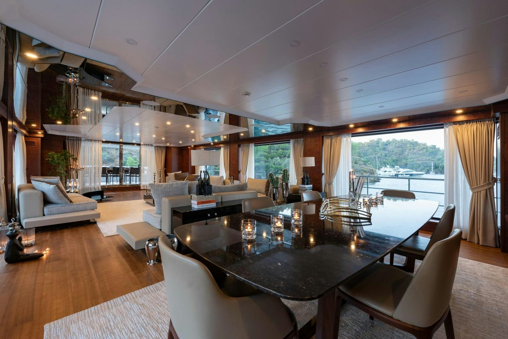 a large living room with a large table and chairs aboard OCEAN BREEZE Yacht for Sale