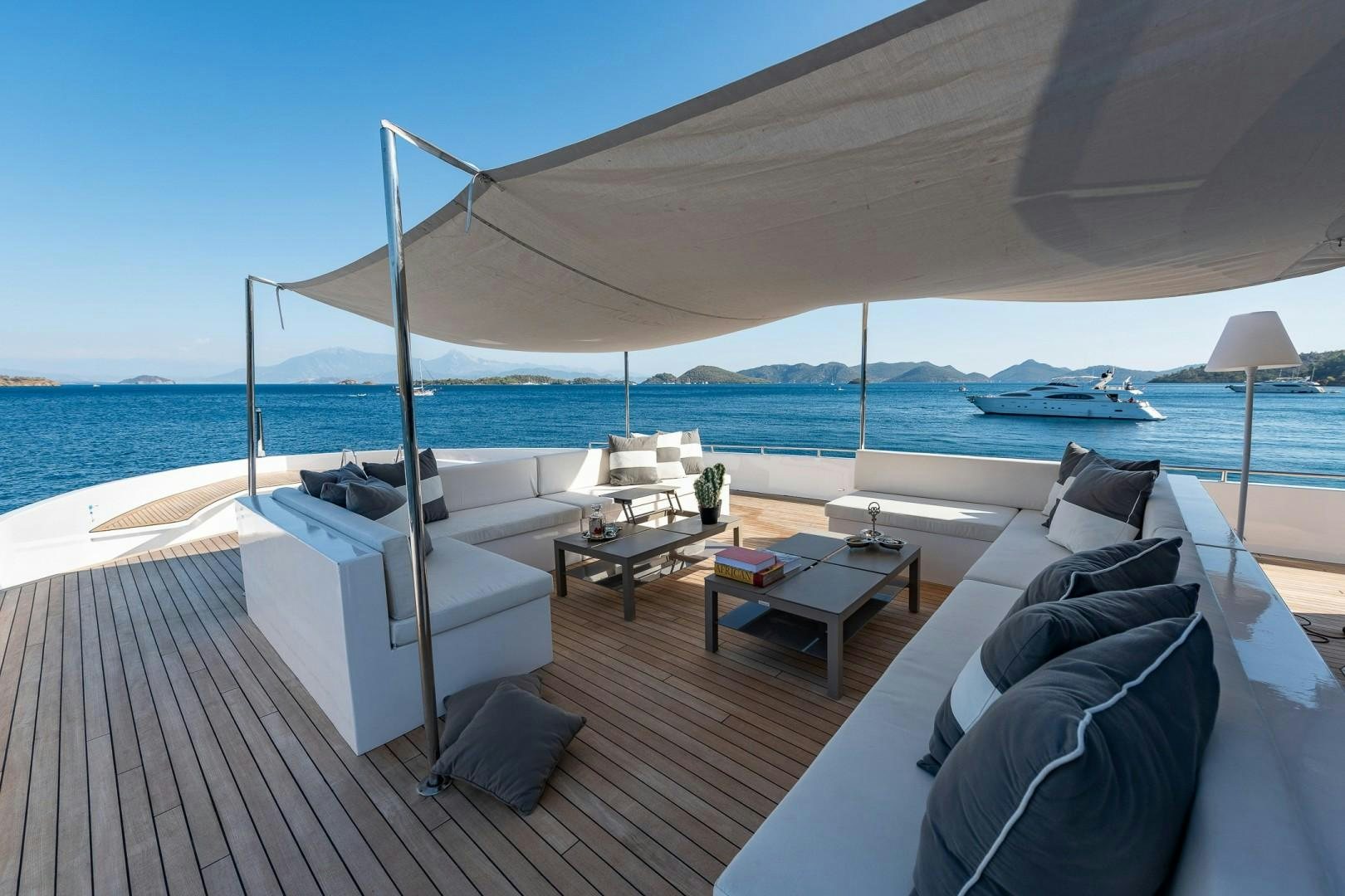 a lounge chair on a deck overlooking the ocean aboard OCEAN BREEZE Yacht for Sale