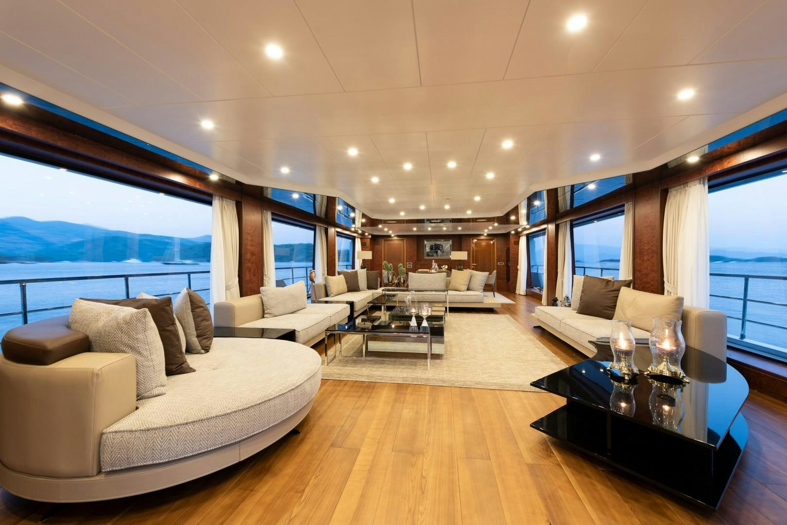 a living room with a large window aboard OCEAN BREEZE Yacht for Sale