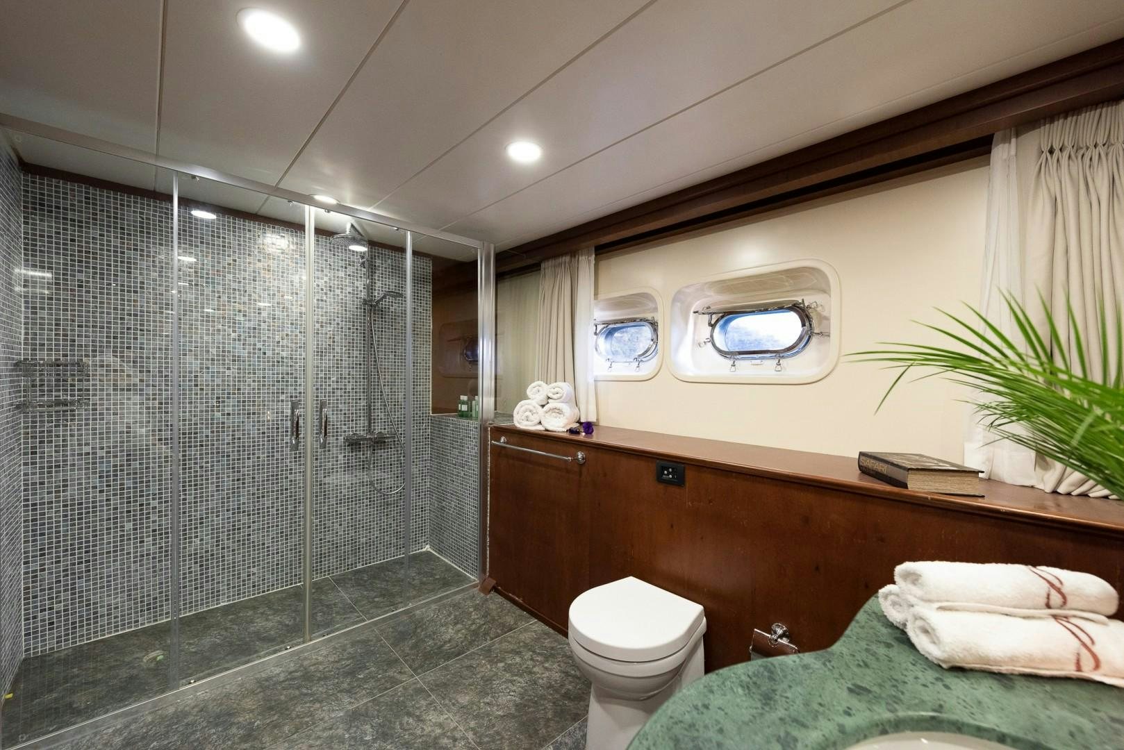 a bathroom with a shower and a toilet aboard OCEAN BREEZE Yacht for Sale