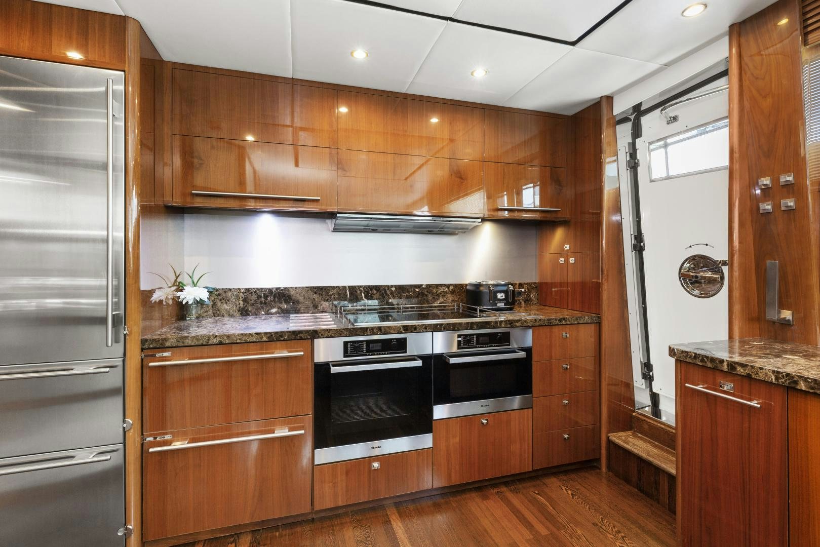 a kitchen with wooden cabinets aboard LOVE N LIFE Yacht for Sale