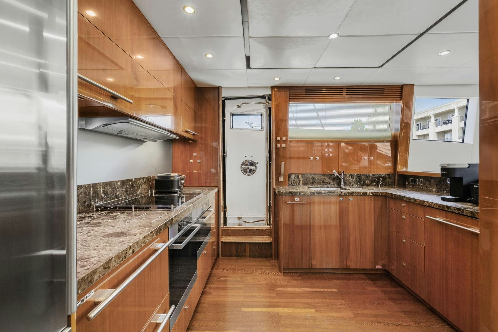 a kitchen with wooden cabinets aboard LOVE N LIFE Yacht for Sale
