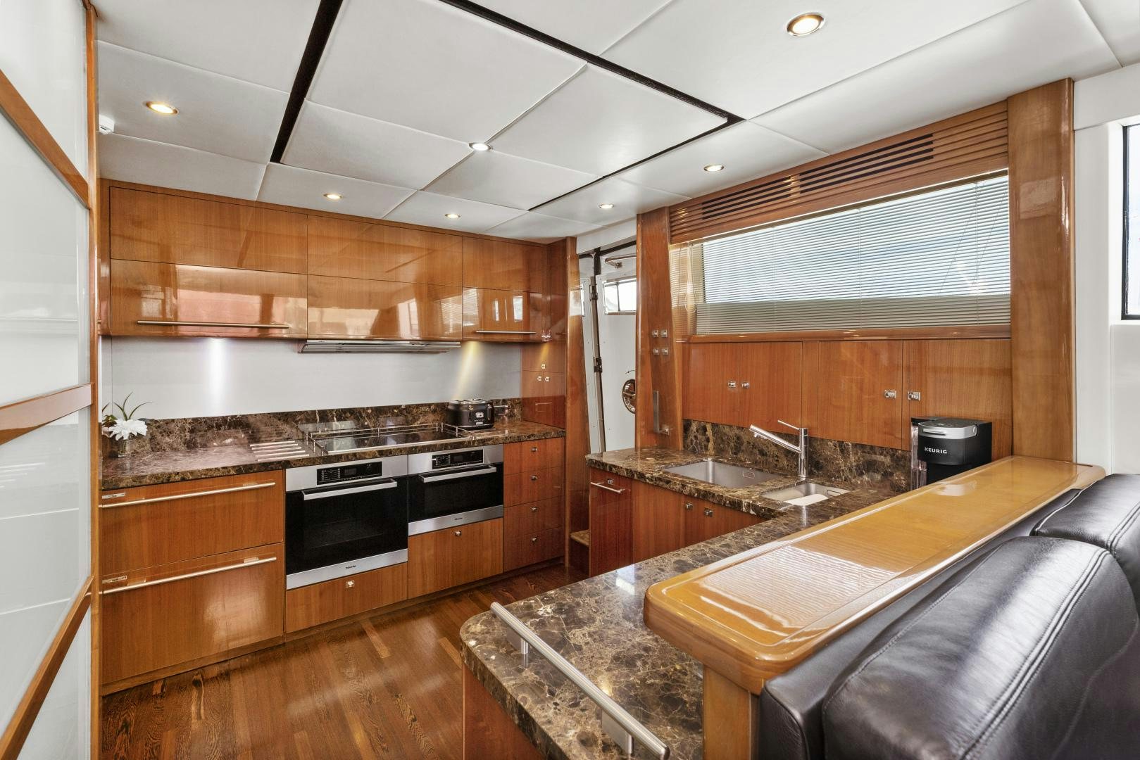 a kitchen with wooden cabinets aboard LOVE N LIFE Yacht for Sale