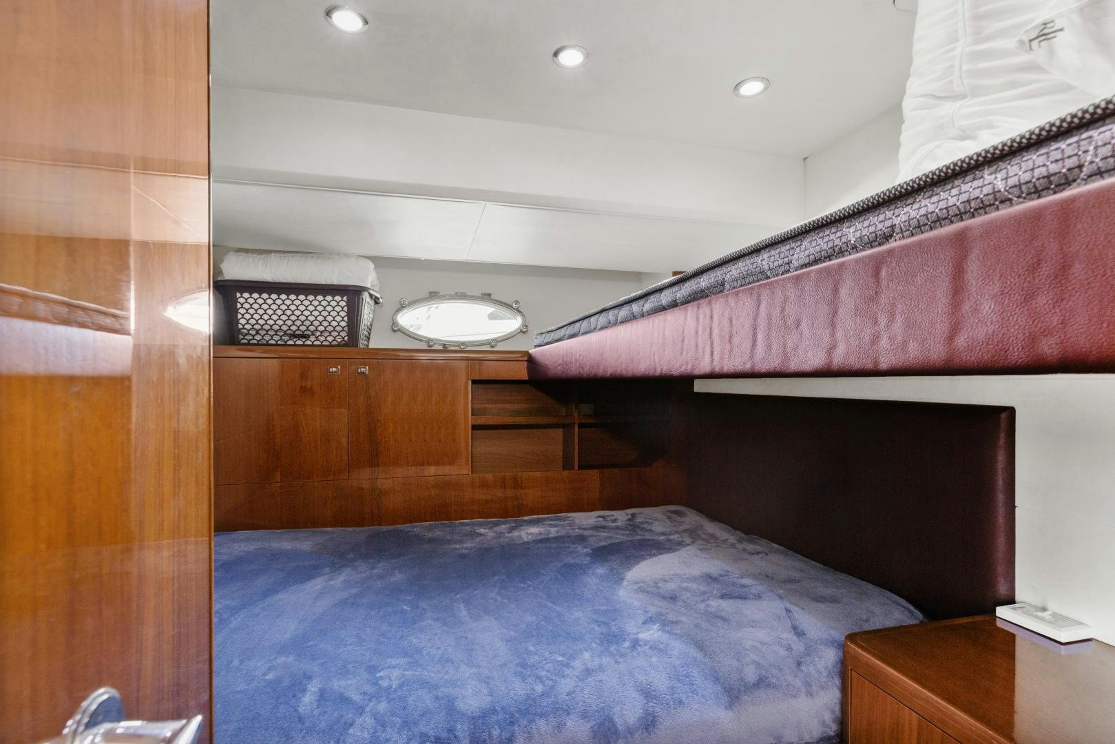 a bedroom with a bed and a wood wall aboard LOVE N LIFE Yacht for Sale
