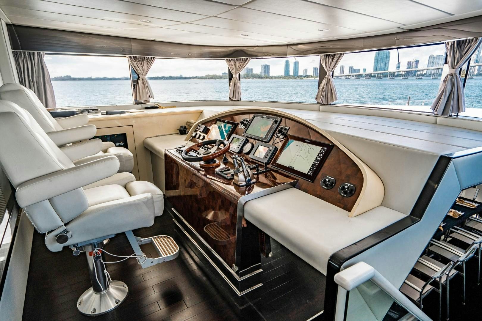 a boat with a large table and chairs on the deck aboard PRIVILEGE Yacht for Sale