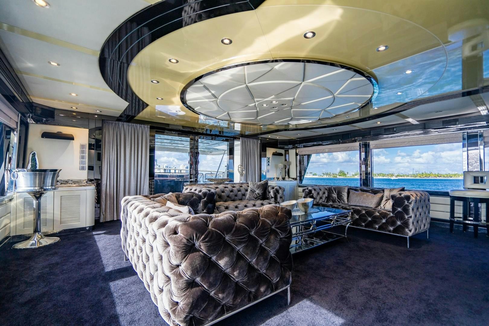 a room with couches and a large fan aboard PRIVILEGE Yacht for Sale