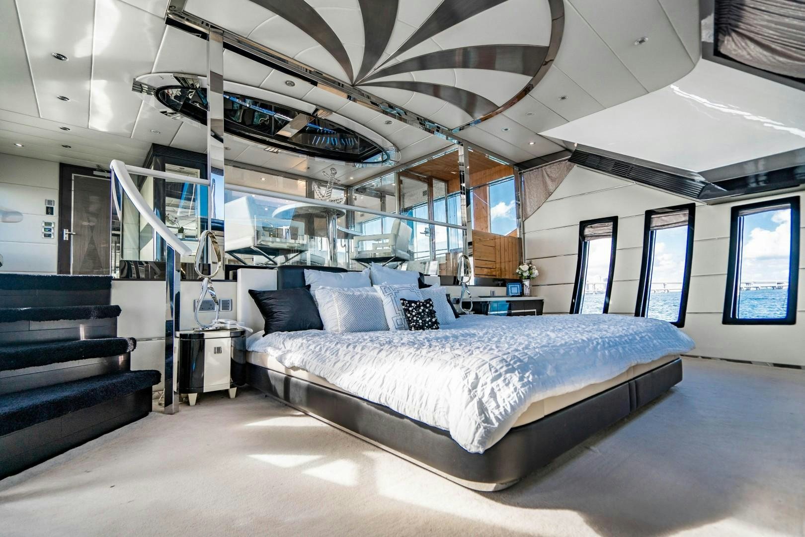 a large room with a bed and a large window aboard PRIVILEGE Yacht for Sale