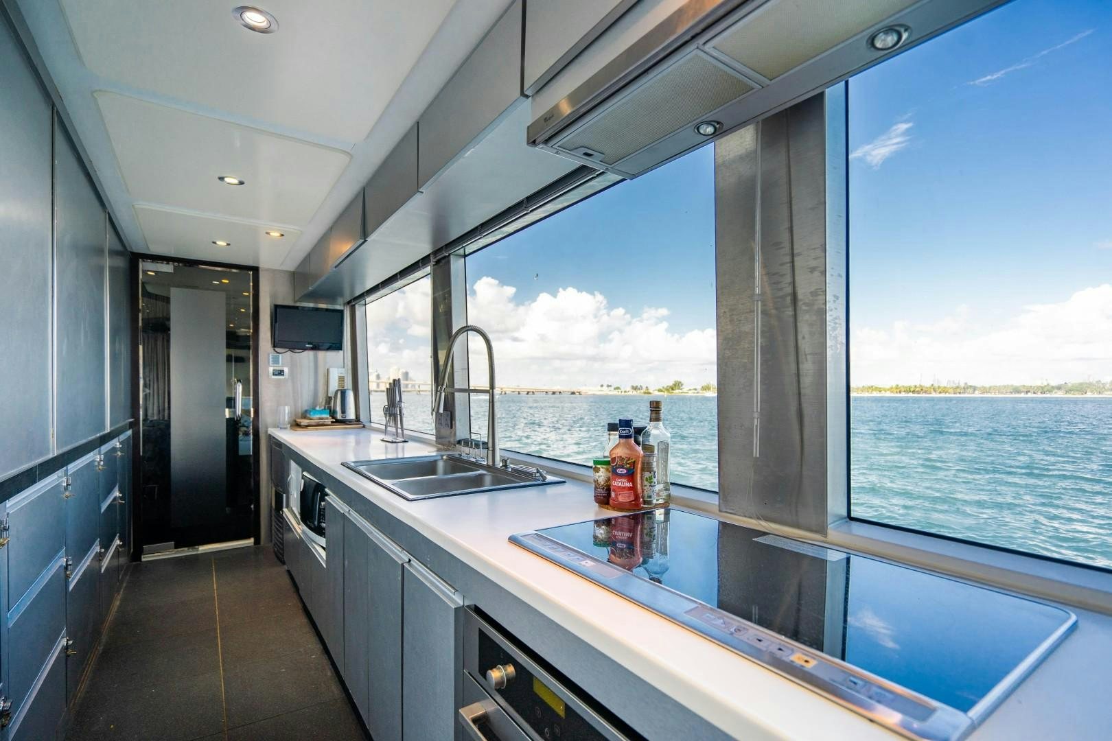 a kitchen with a large window aboard PRIVILEGE Yacht for Sale