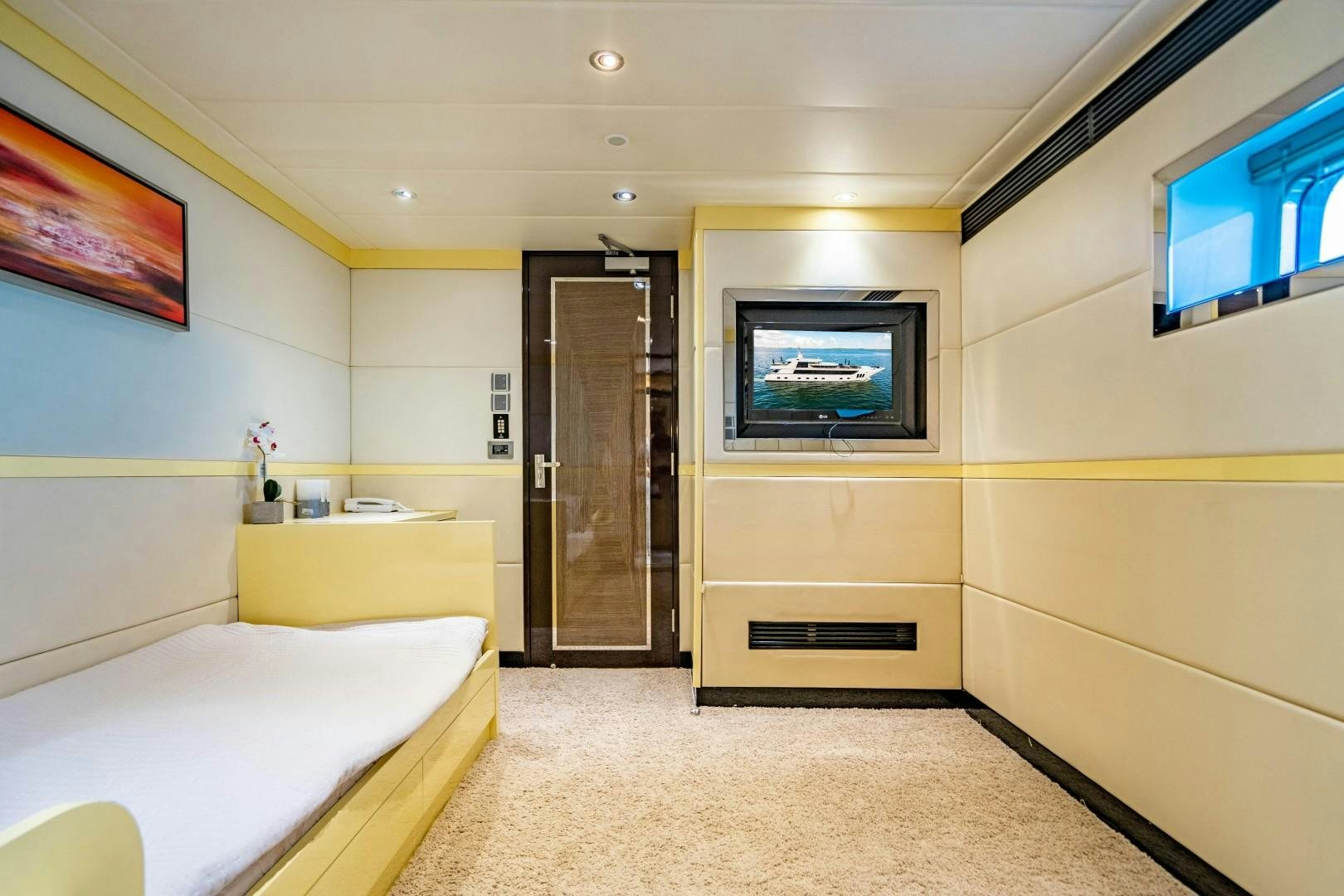 a room with a bed and a tv aboard PRIVILEGE Yacht for Sale