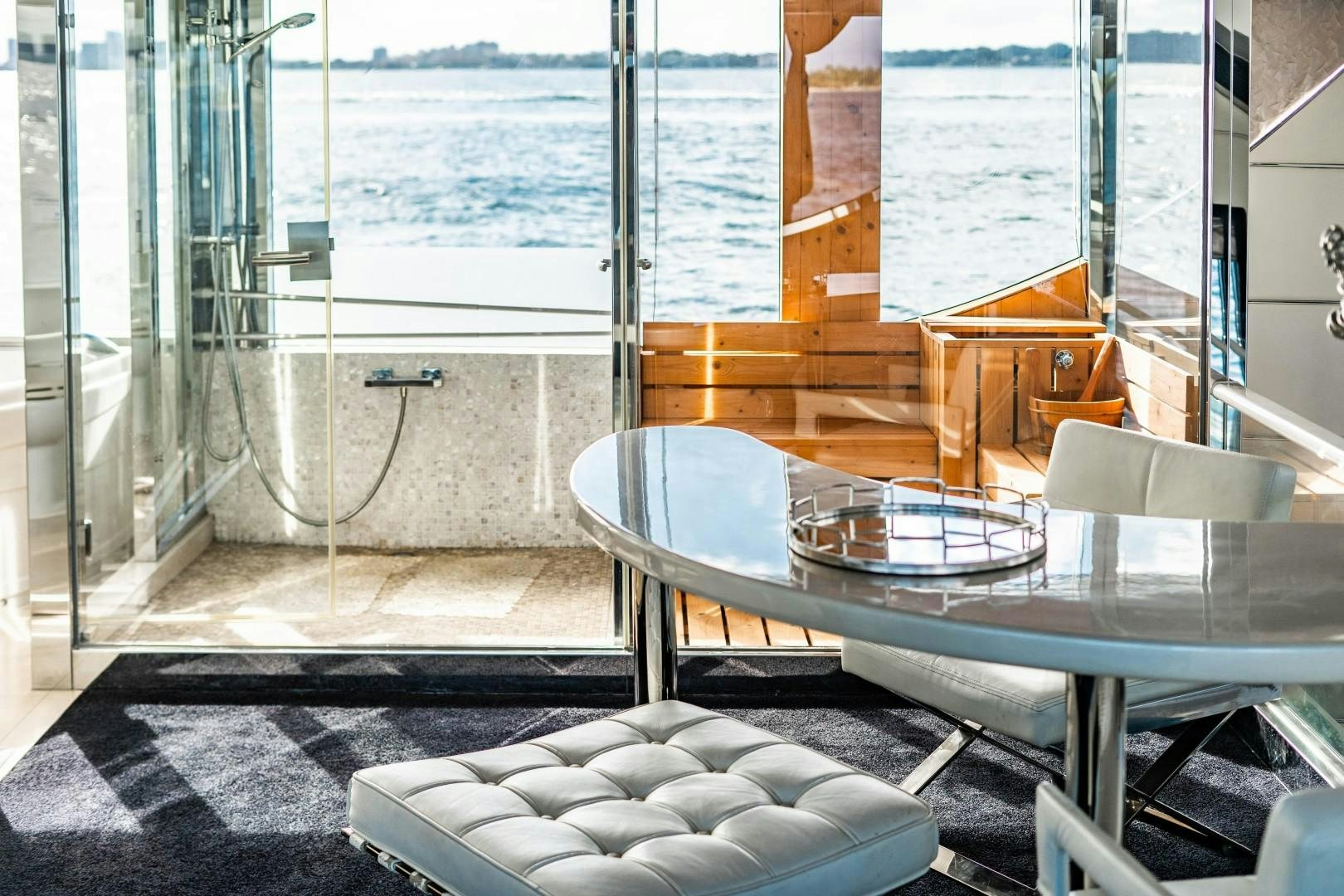a table and chairs on a balcony aboard PRIVILEGE Yacht for Sale