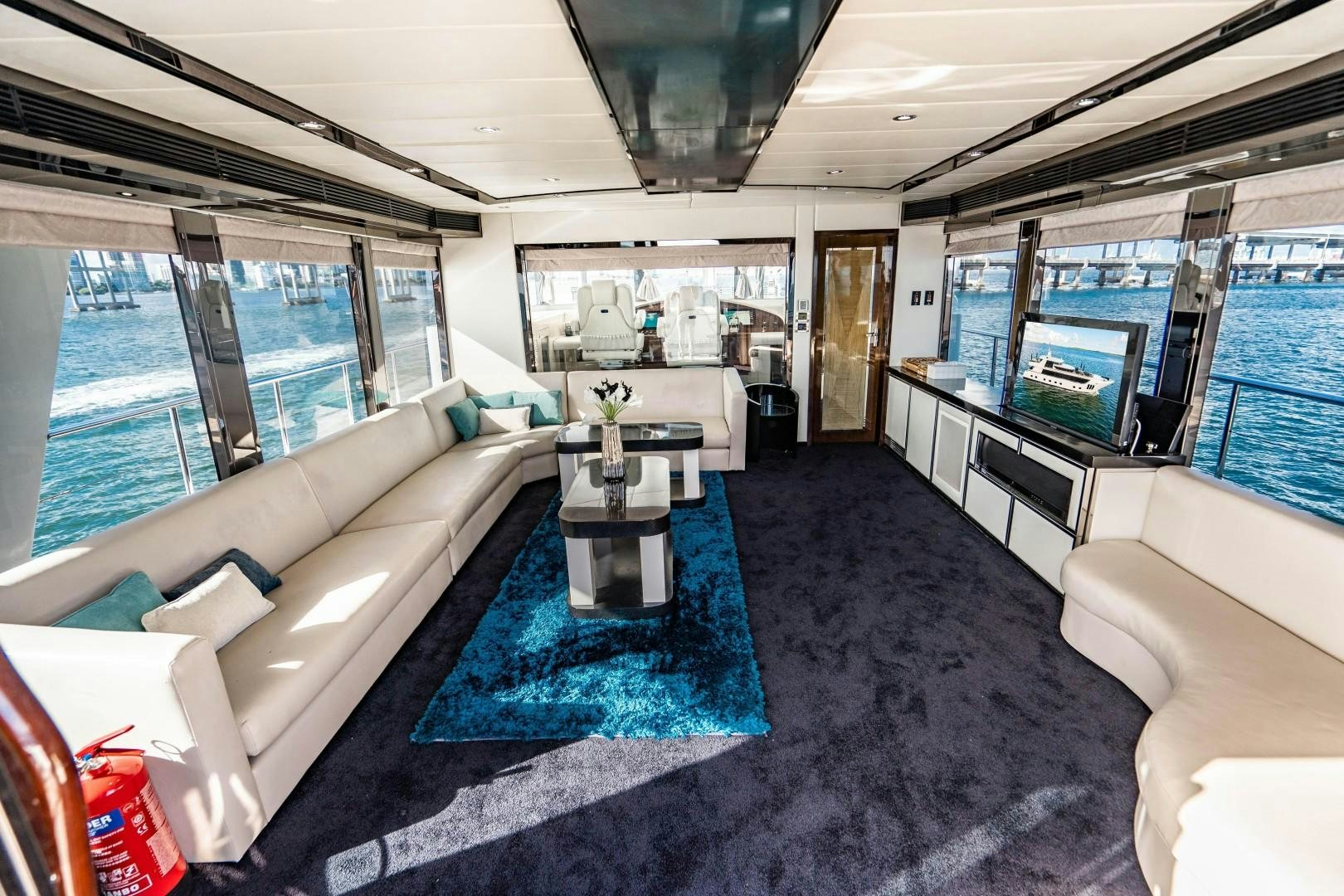 a living room with a large blue rug aboard PRIVILEGE Yacht for Sale