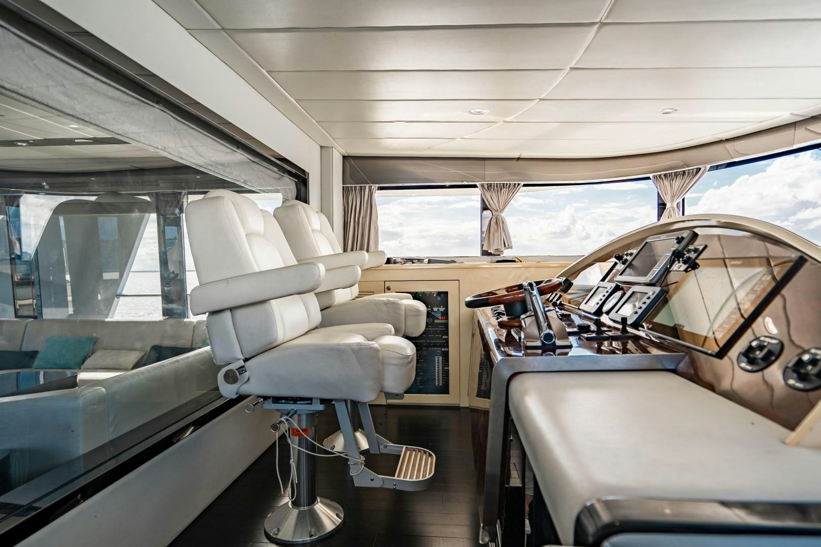 a room with a bed and a chair aboard PRIVILEGE Yacht for Sale