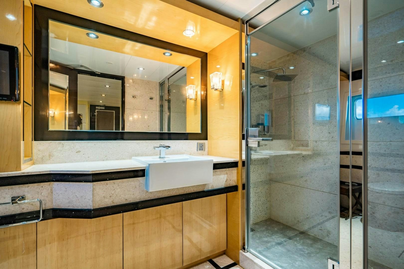 a bathroom with a large mirror aboard PRIVILEGE Yacht for Sale