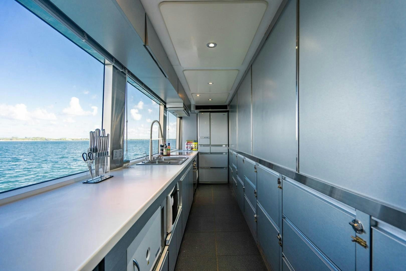 a kitchen with a large window aboard PRIVILEGE Yacht for Sale