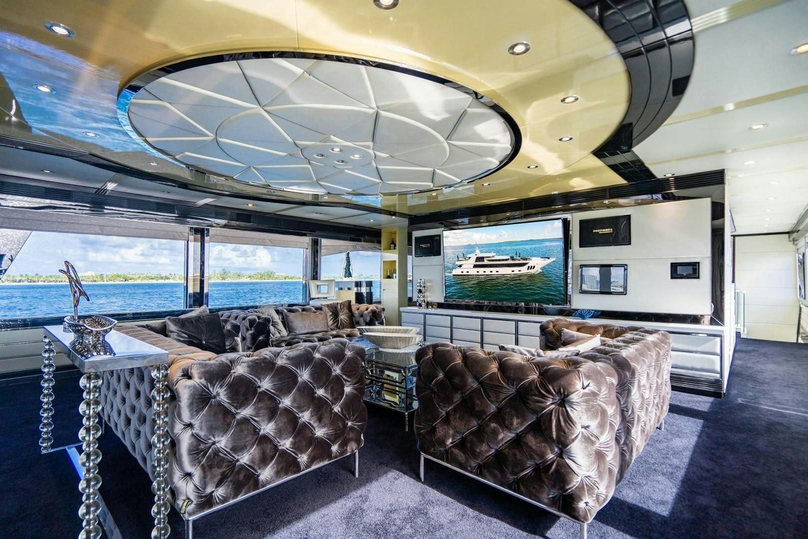 a room with couches and chairs aboard PRIVILEGE Yacht for Sale
