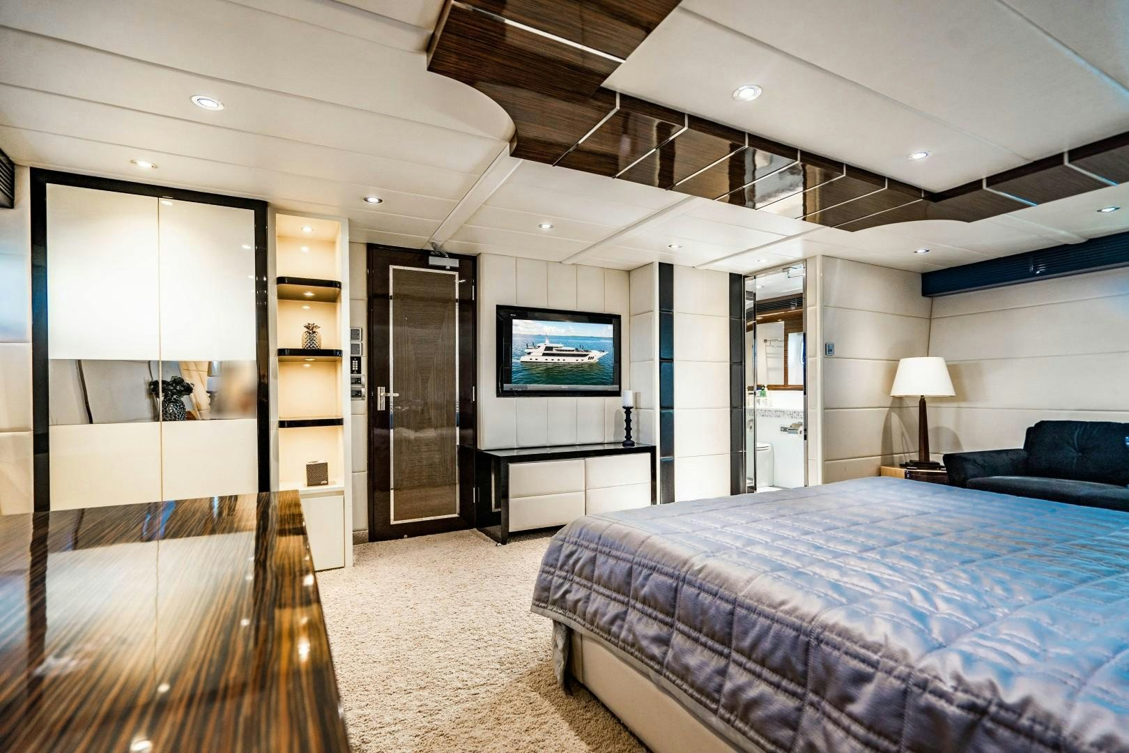 a bedroom with a bed and a tv aboard PRIVILEGE Yacht for Sale