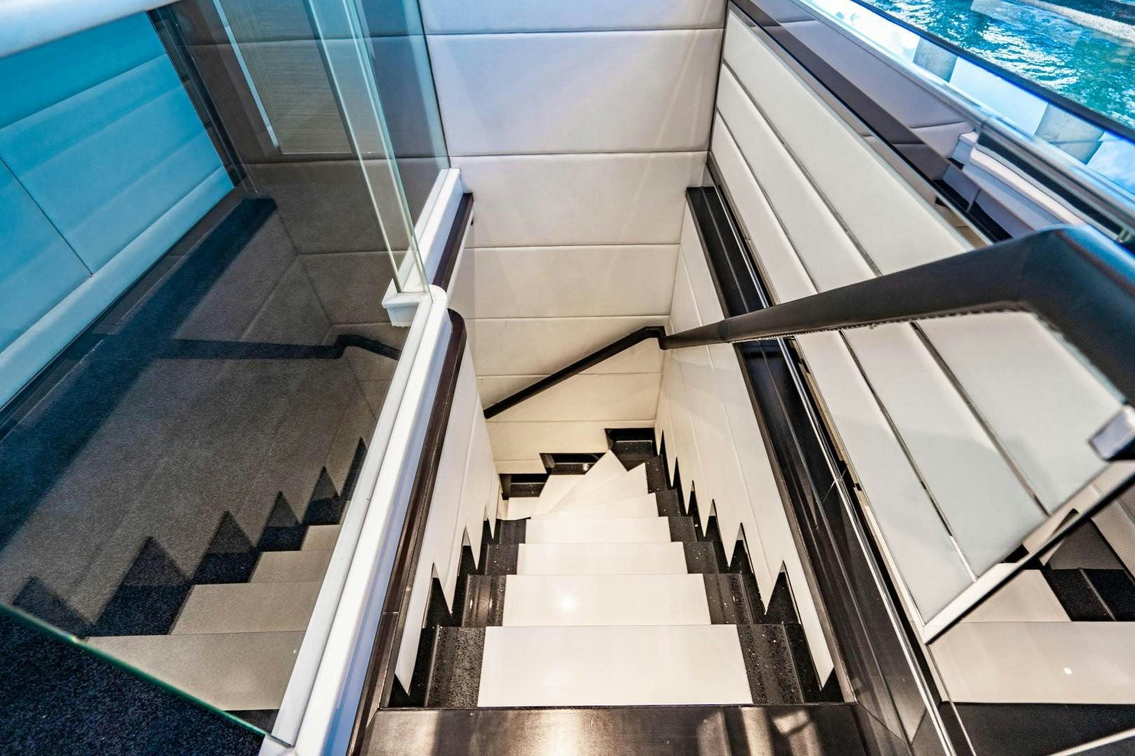 a staircase with glass walls aboard PRIVILEGE Yacht for Sale