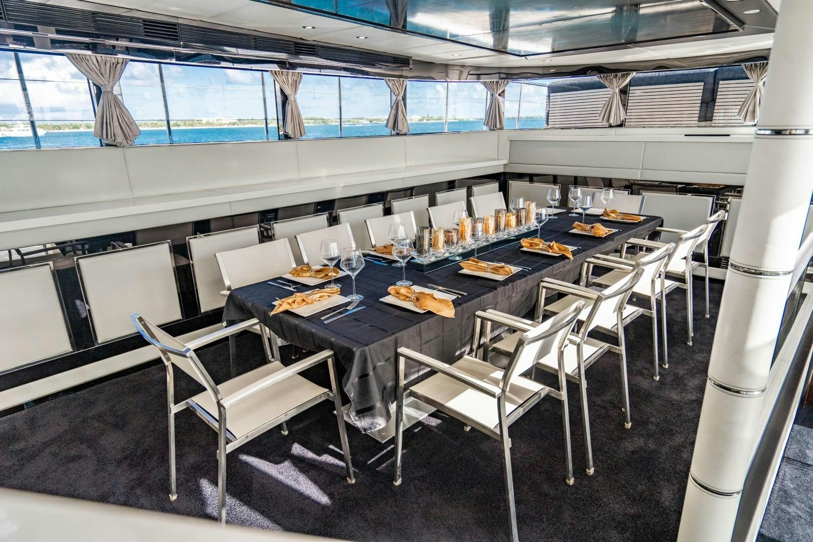 a large table with chairs around it aboard PRIVILEGE Yacht for Sale