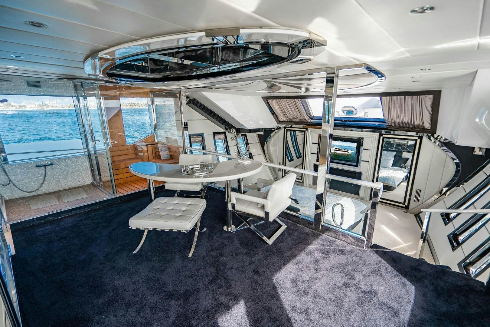 a room with a table and chairs aboard PRIVILEGE Yacht for Sale