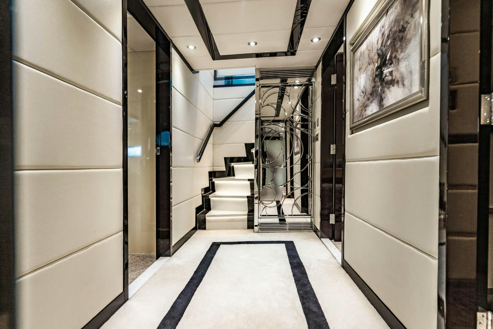 a hallway with a staircase and a large mirror aboard PRIVILEGE Yacht for Sale