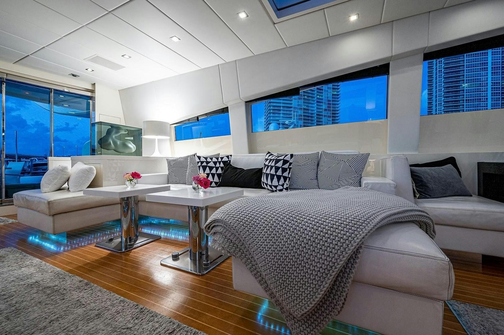 a large living room with a large window aboard CASSINELLA Yacht for Sale