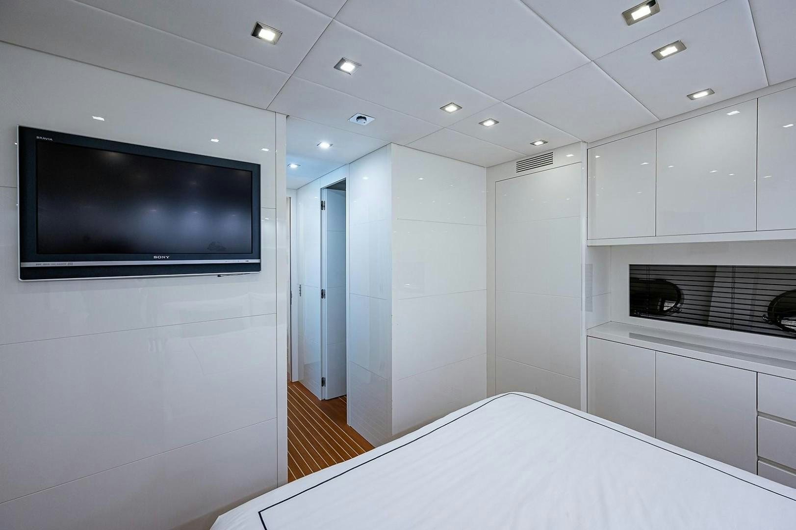 a large white room with a tv aboard CASSINELLA Yacht for Sale