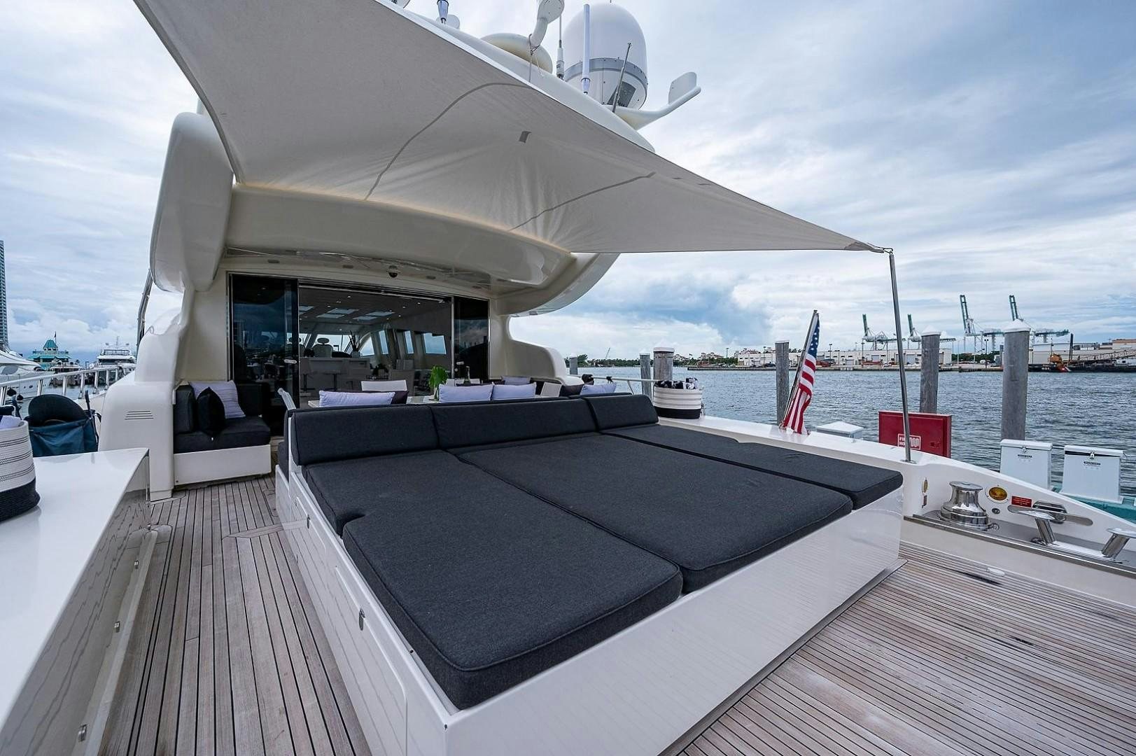 a deck with a large boat on it and a flag on the side aboard CASSINELLA Yacht for Sale