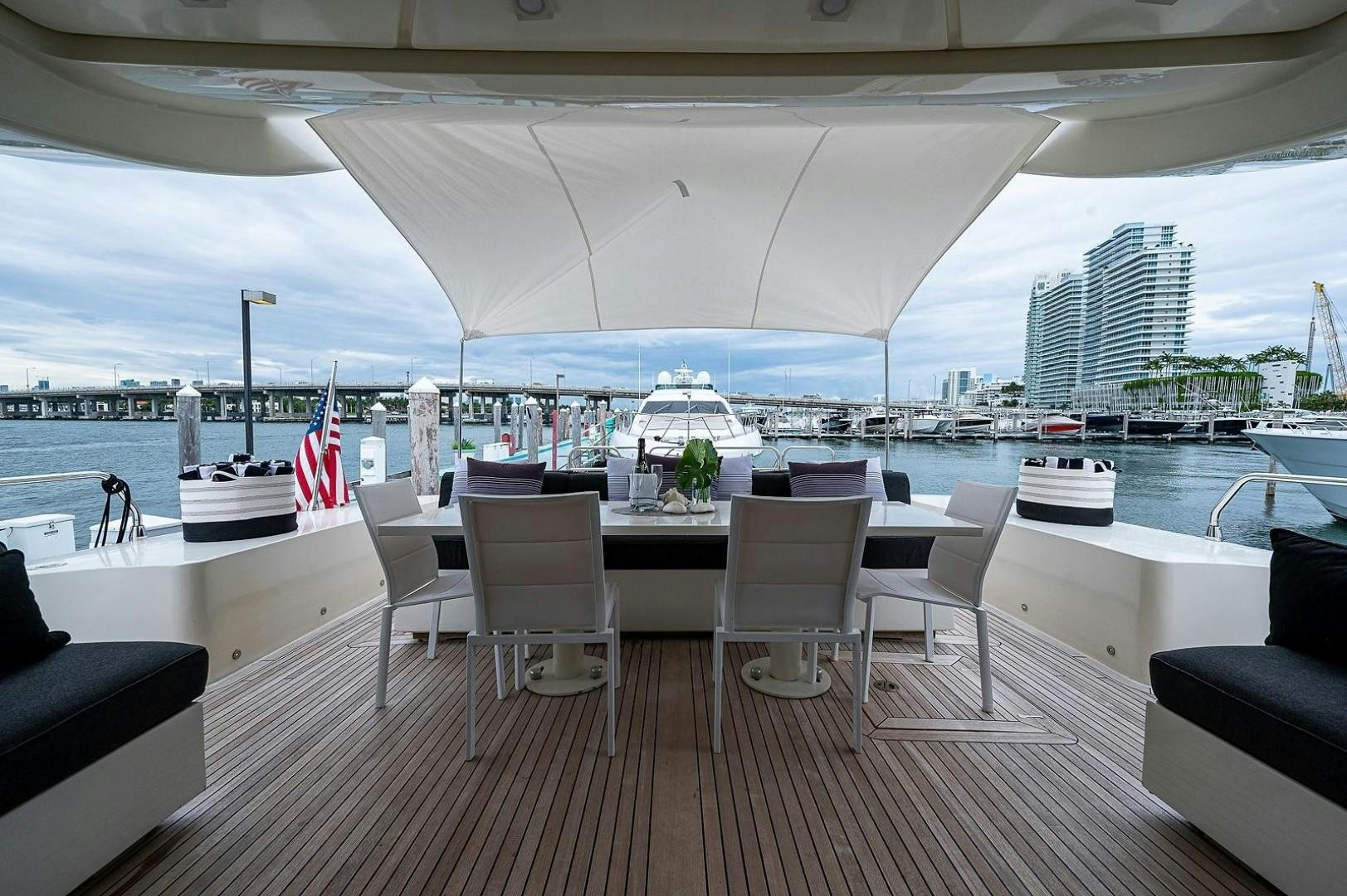 a deck with a view of a city and water aboard CASSINELLA Yacht for Sale