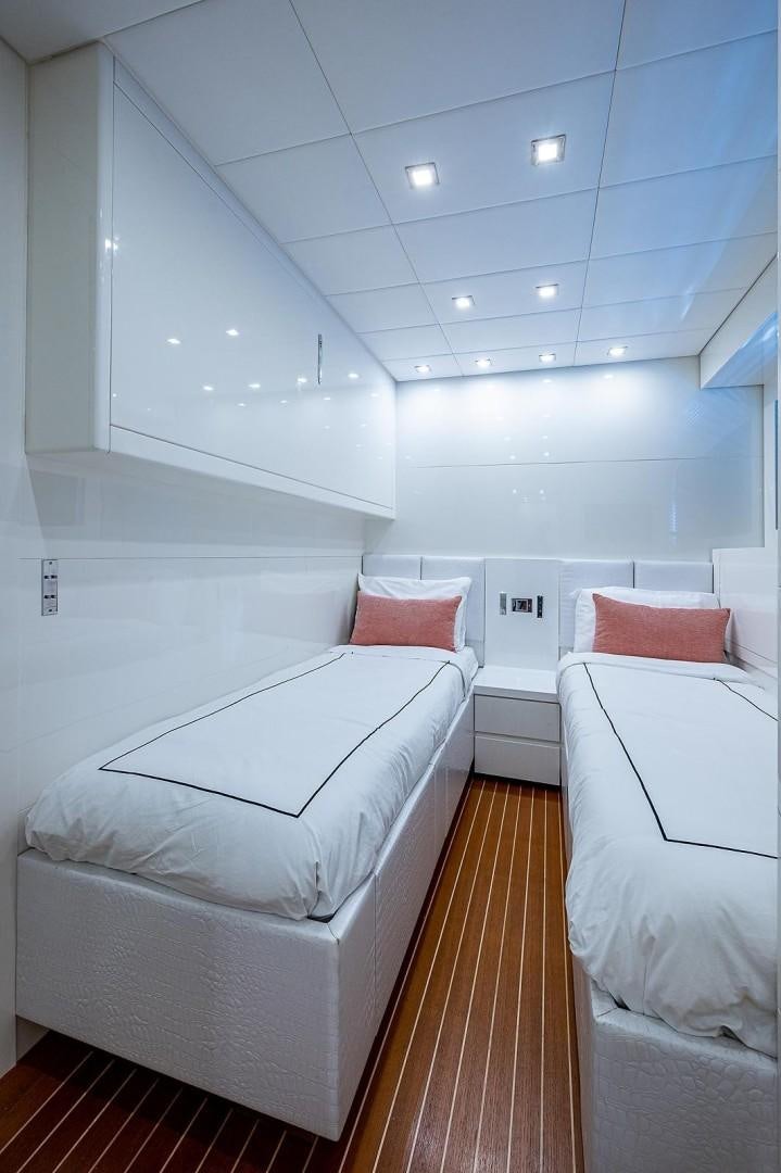 a room with white beds aboard CASSINELLA Yacht for Sale