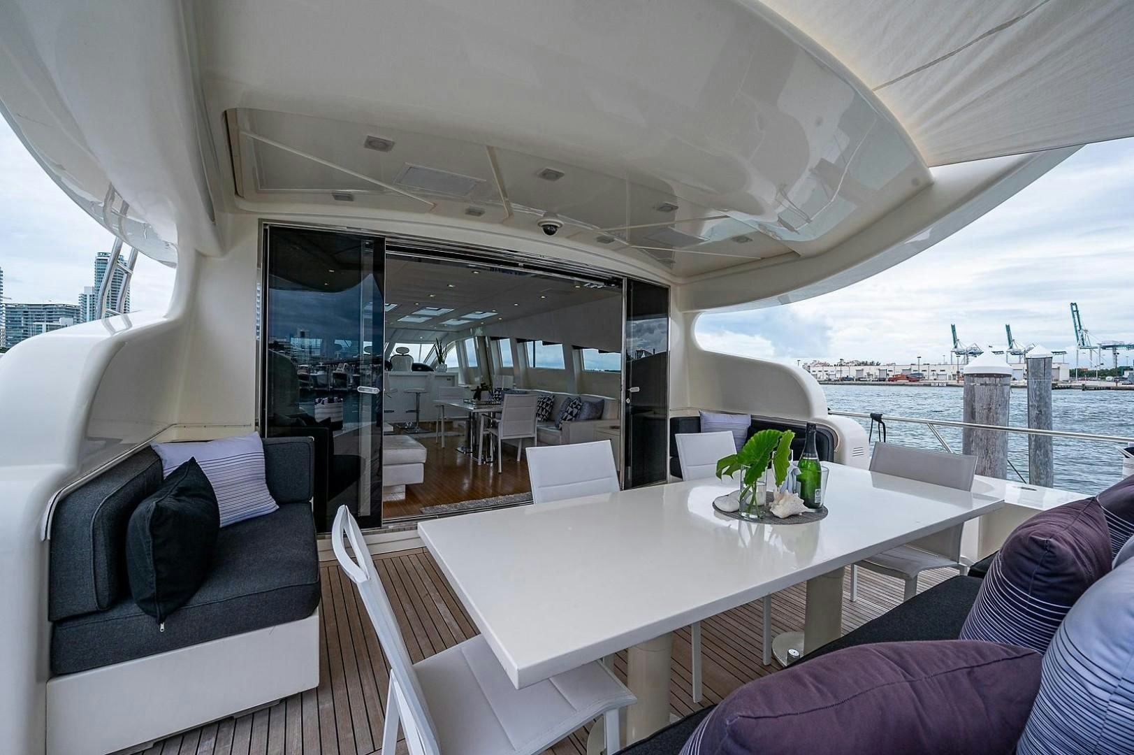 a large white table with a white table and chairs on it aboard CASSINELLA Yacht for Sale