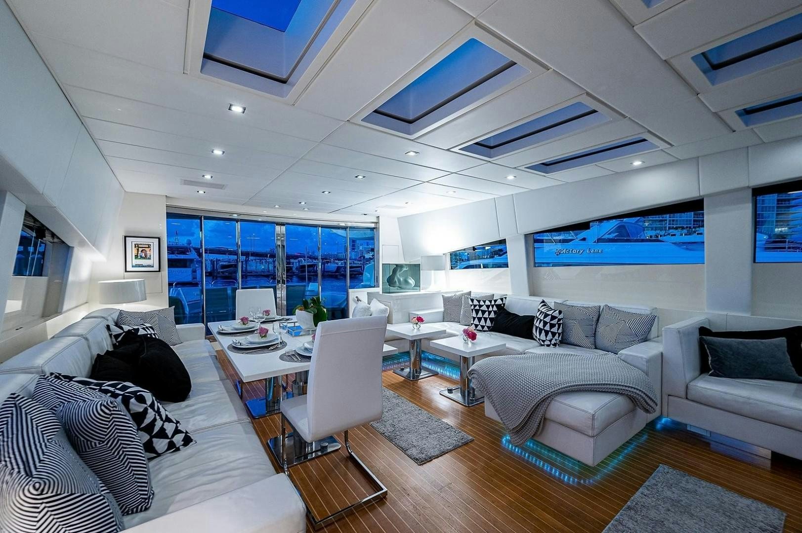 a living room with a large window aboard CASSINELLA Yacht for Sale