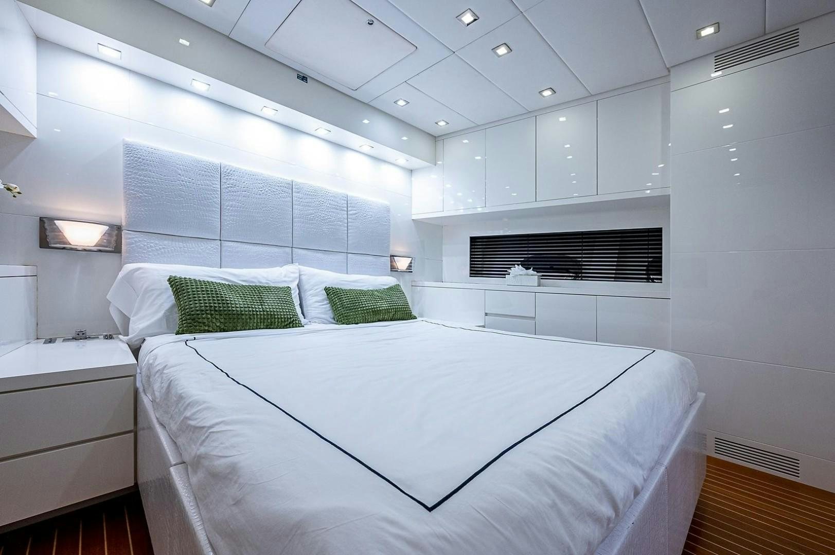 a white bed in a room aboard CASSINELLA Yacht for Sale