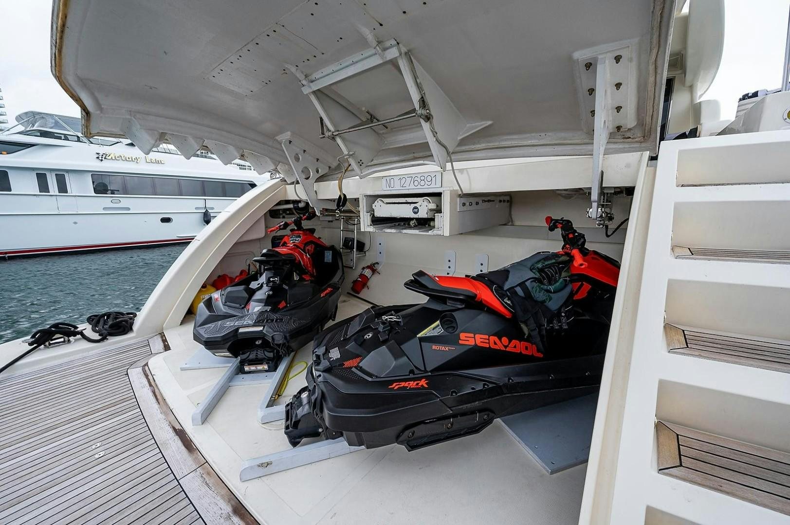 a boat with a motor and a couple of motorbikes on it aboard CASSINELLA Yacht for Sale