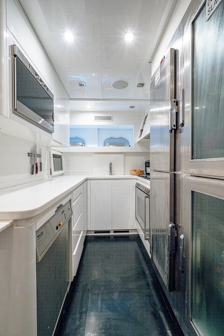 a kitchen with a large refrigerator aboard CASSINELLA Yacht for Sale