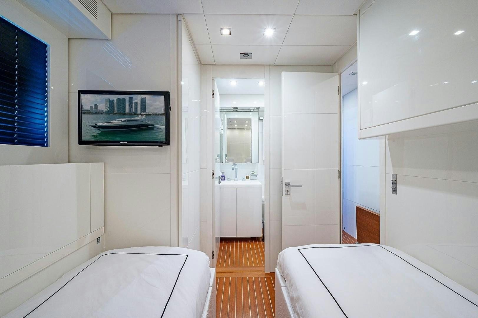 a room with white walls and a wood floor and a picture on the wall aboard CASSINELLA Yacht for Sale