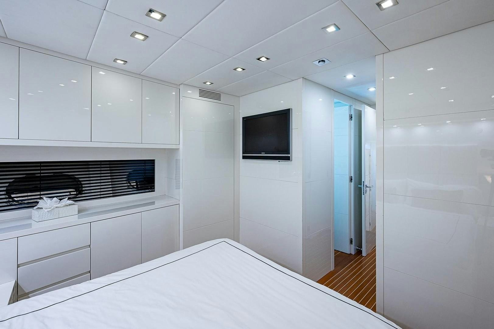 a room with a tv and cabinets aboard CASSINELLA Yacht for Sale