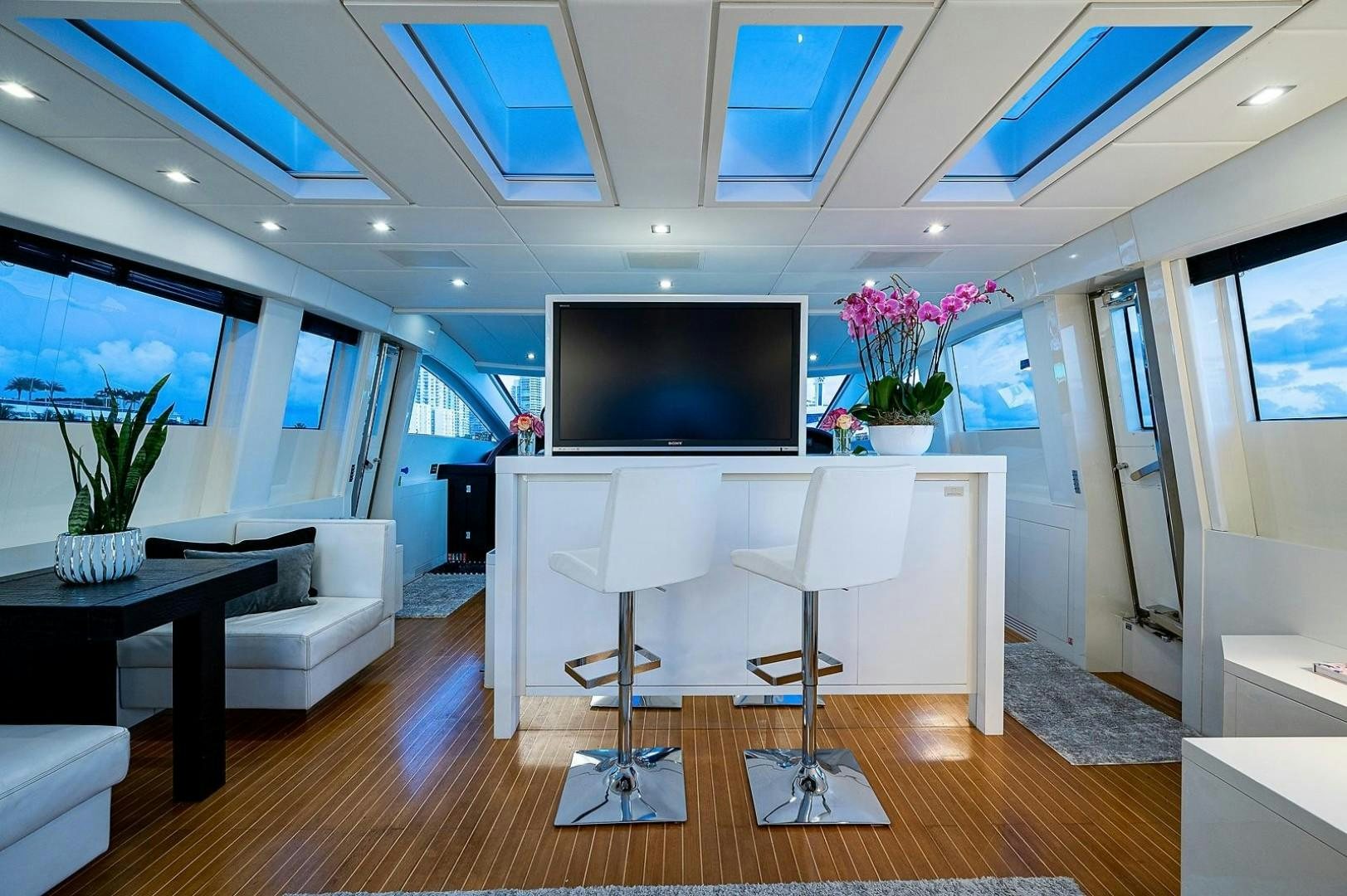 a room with a table and chairs aboard CASSINELLA Yacht for Sale