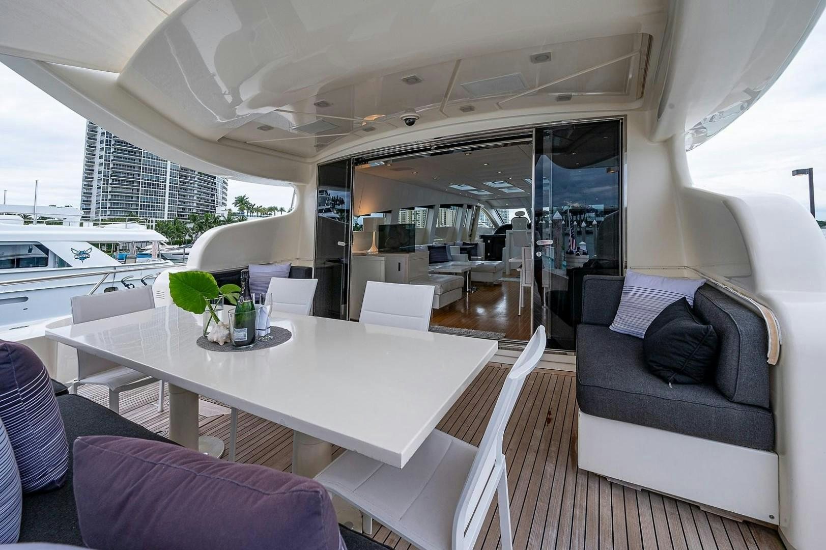 a room with a table and couch aboard CASSINELLA Yacht for Sale