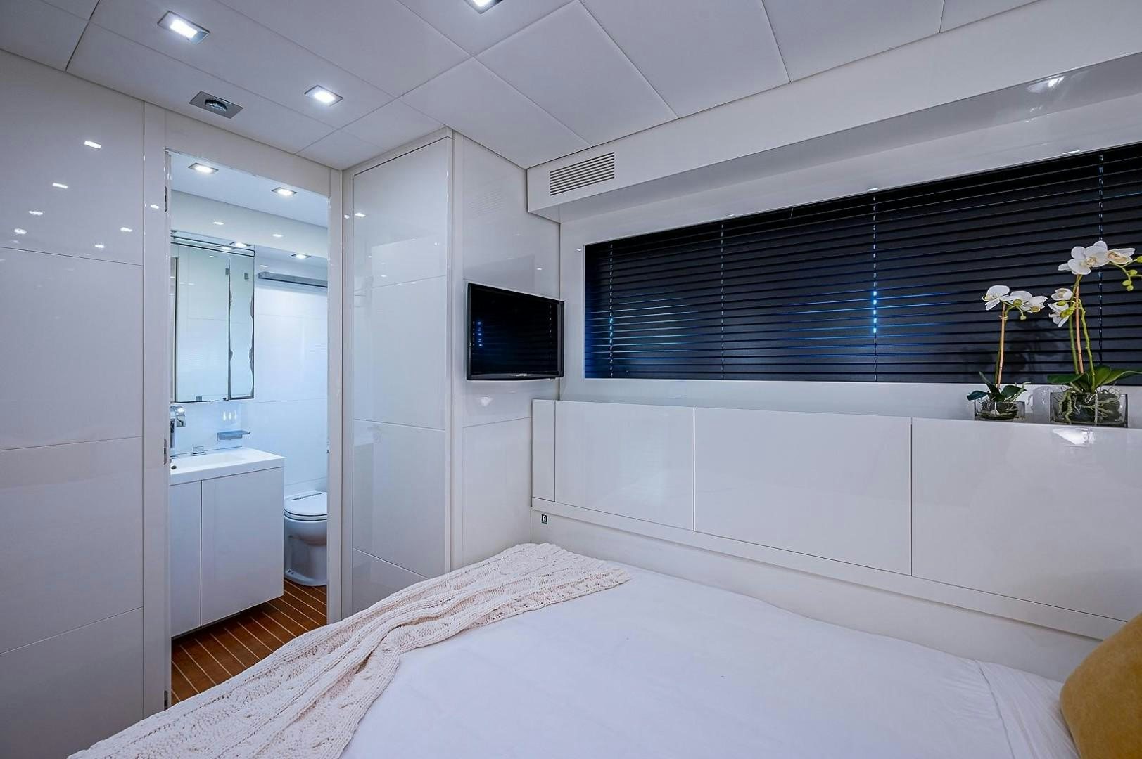 a bedroom with a bed and a television aboard CASSINELLA Yacht for Sale
