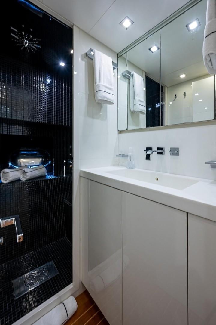 a bathroom with a black shower curtain aboard CASSINELLA Yacht for Sale