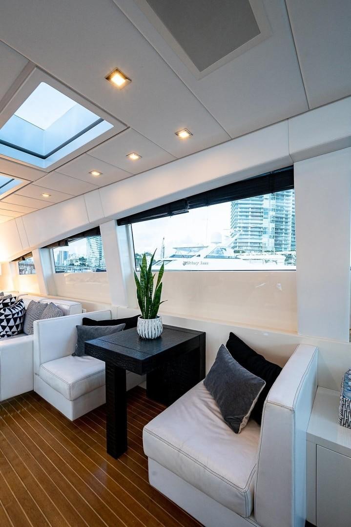 a living room with a large window aboard CASSINELLA Yacht for Sale