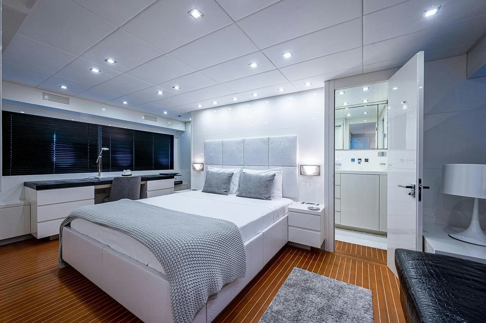 a large bedroom with a large bed aboard CASSINELLA Yacht for Sale