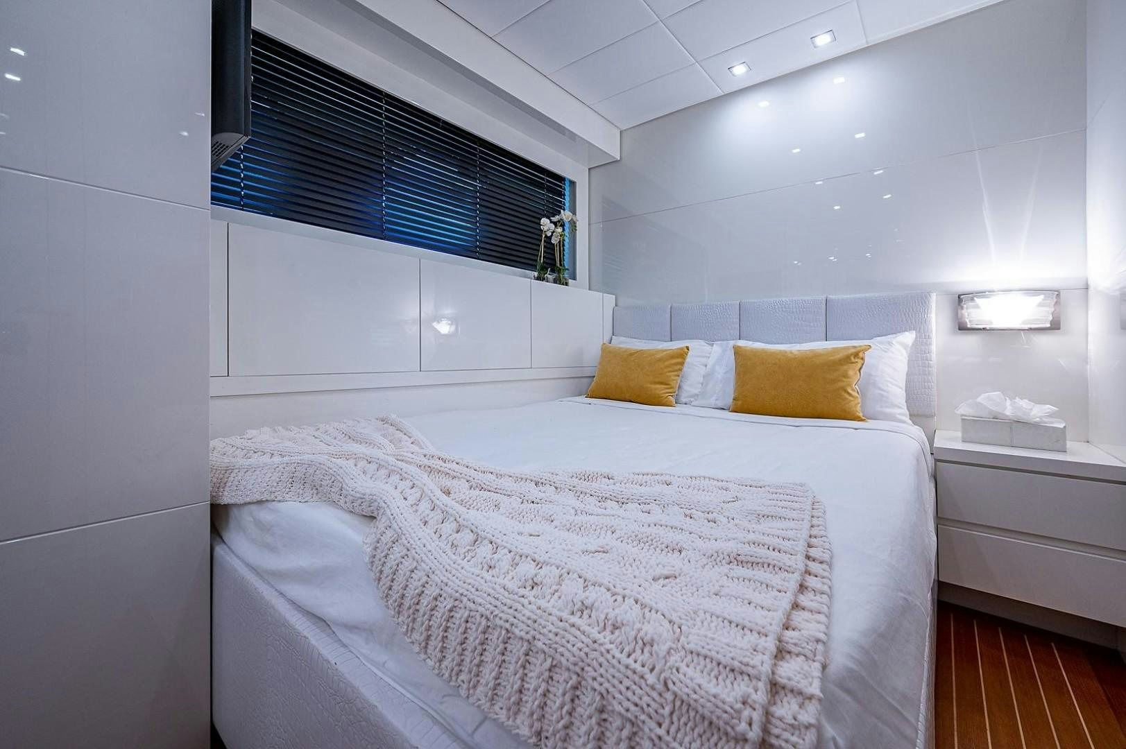 a bed with white sheets aboard CASSINELLA Yacht for Sale