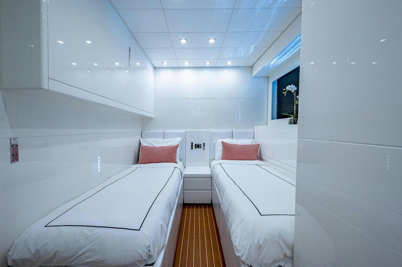 a room with white beds aboard CASSINELLA Yacht for Sale