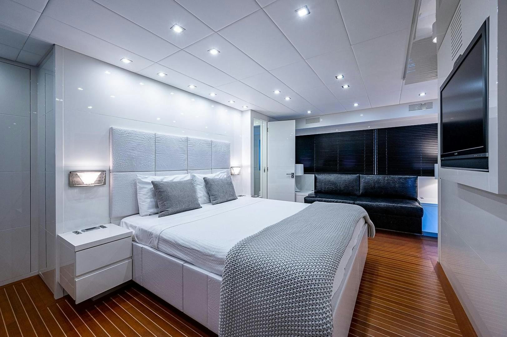 a bedroom with a bed and a couch aboard CASSINELLA Yacht for Sale