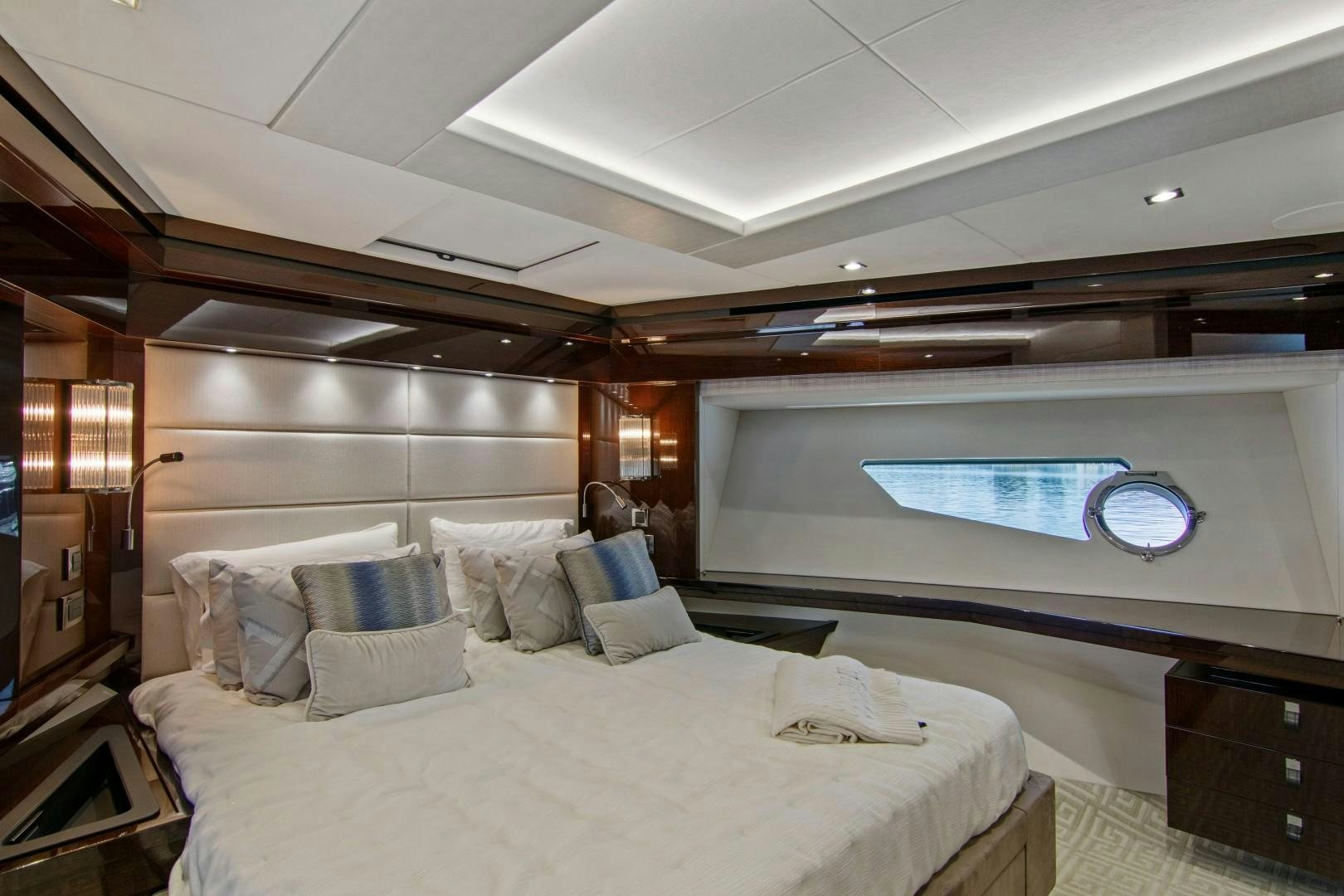 a room with a large bed and a large screen aboard GOLDEN OURS Yacht for Sale