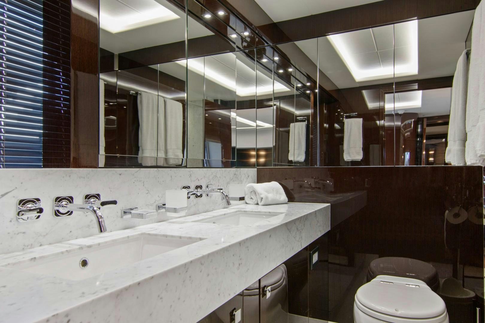 a bathroom with a large mirror aboard GOLDEN OURS Yacht for Sale