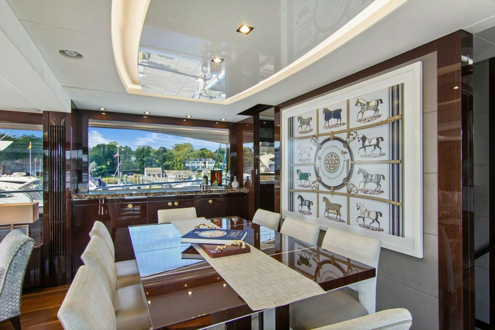 a dining room with a table and chairs aboard GOLDEN OURS Yacht for Sale